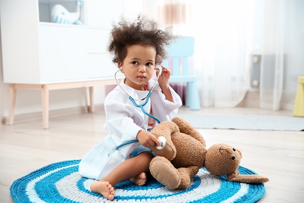 Child holding a stethoscope to their teddy bear